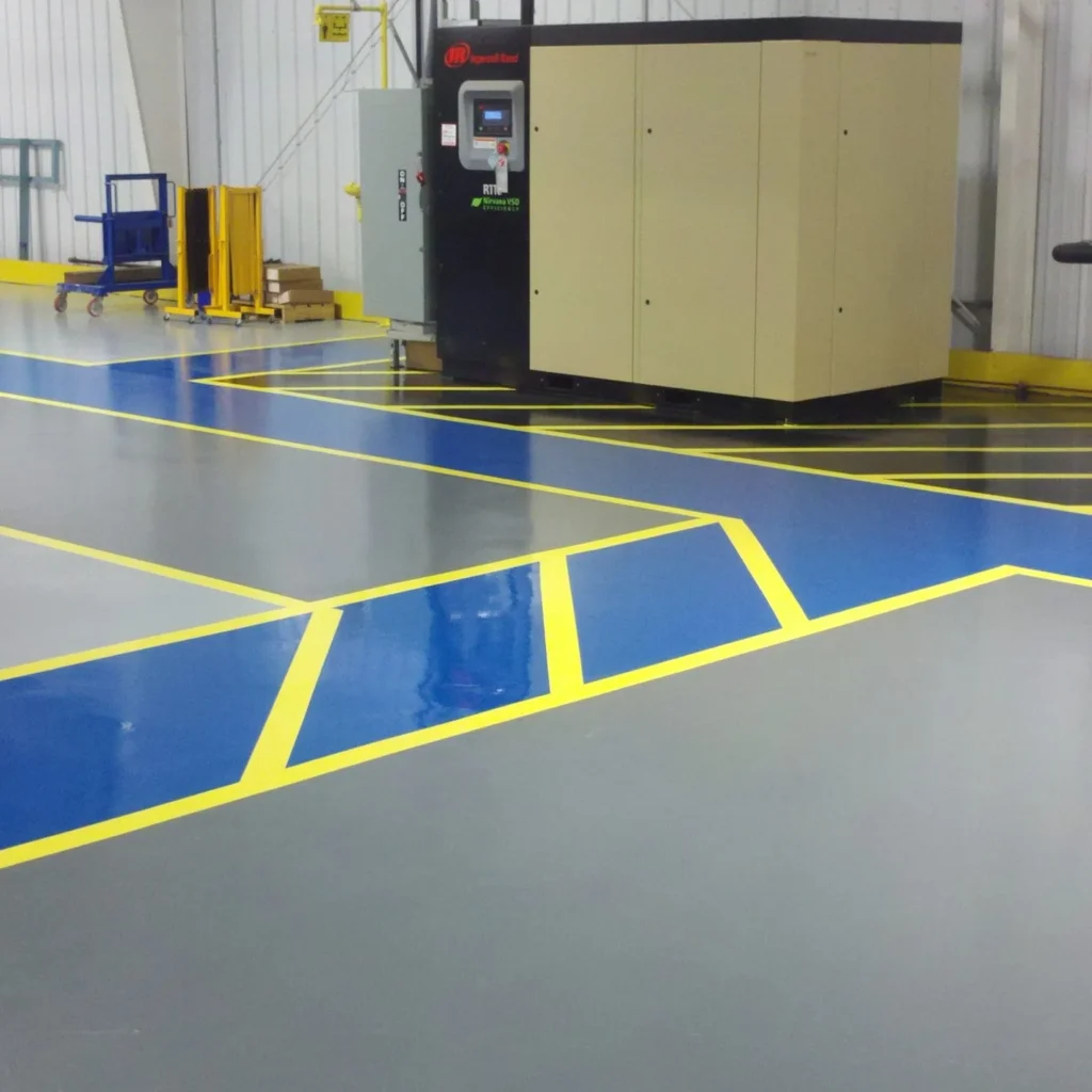 Industrial resin flooring system applied in a factory environment for heavy-duty use